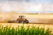 © marketanovakova - Tractor ploughing the field in sunset with dust in the air