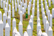 Potocari, Bosnia And Herzegovina - July 31, 2019. Green Grave Of Last DNA Identified Victim Of Srebrenica Massacre Between White Tombstones