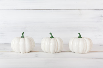 White pumpkin on white wood table with copy space.