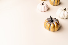 Colorful Painted Pumpkins On White Table With Copy Space