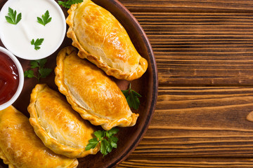 Wall Mural - Latin American baked beef empanadas with sauce