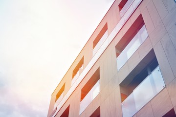 Modern apartment buildings on a sunny day with a blue sky. Facade of a modern apartment building.Glass surface with sunlight.