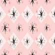 Atomic age starburst seamless pattern inspired by 1960's kitsch. Pink and black repeat that shows the stylized mid century look, common with space age advertising, textiles, paper, fashion and decor.