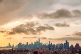Fototapeta Miasta - Cityscape of the New York City Skyline that includes Brooklyn and Manhattan under a cloud filled sky in the evening.