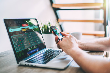 Man making bets online at bookmaker's webcite.