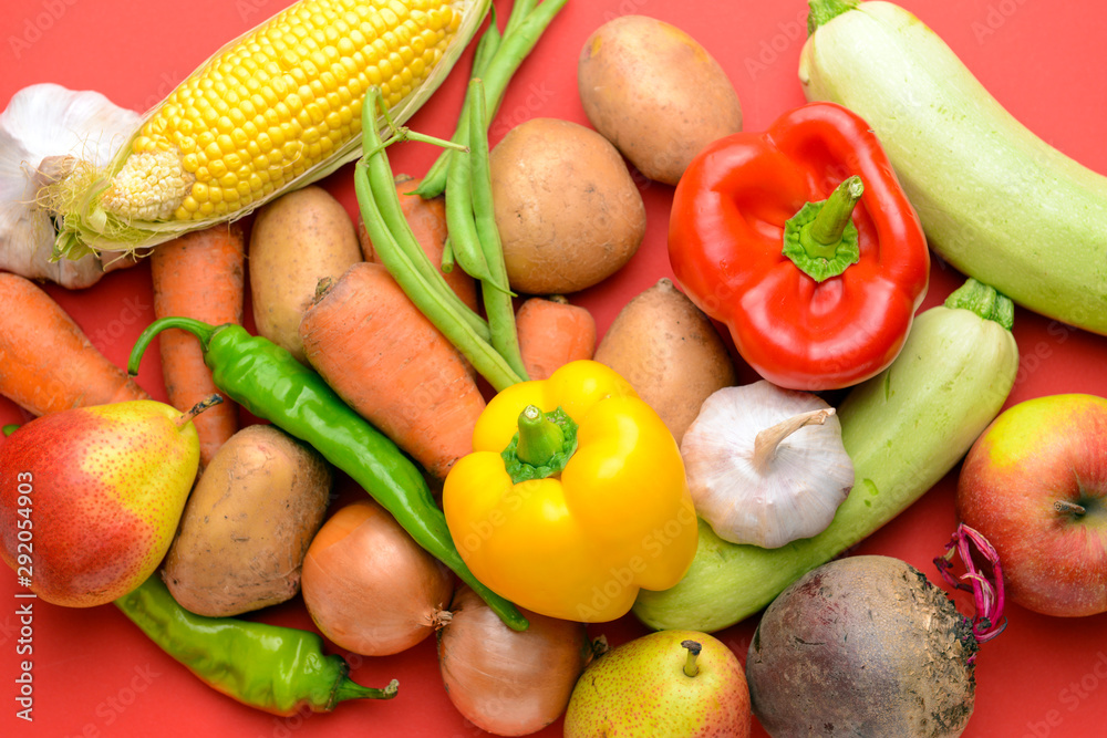 Many healthy vegetables and fruits on color background