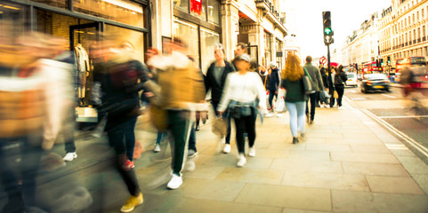 Canvas Print - Motion blurred people on busy street of shops