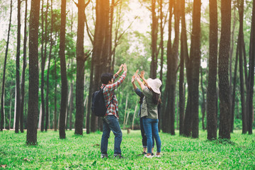 Canvas Print - Closeup image of travelers putting their hands together in the forest