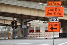 Traffic Detour Signs In Downtown Rush Hour With Traffic Light Road Closure