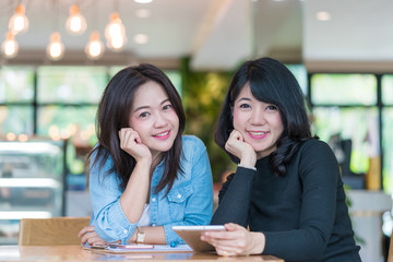 business woman working together with tablet at coffee shop