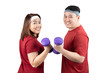 Portrait of happy young overweight Asian couple smiling and exercising with dumbbells together isolated on white background with copy space. Healthy lifestyle, body shape and sport concept.