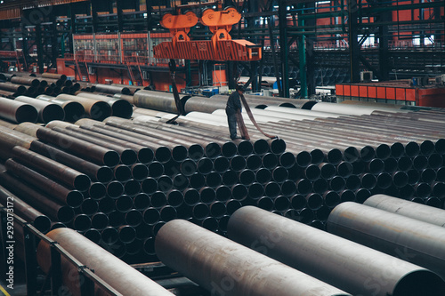 Fotomural heavy industry concept, construction machinery - long metal pipes inside a large room