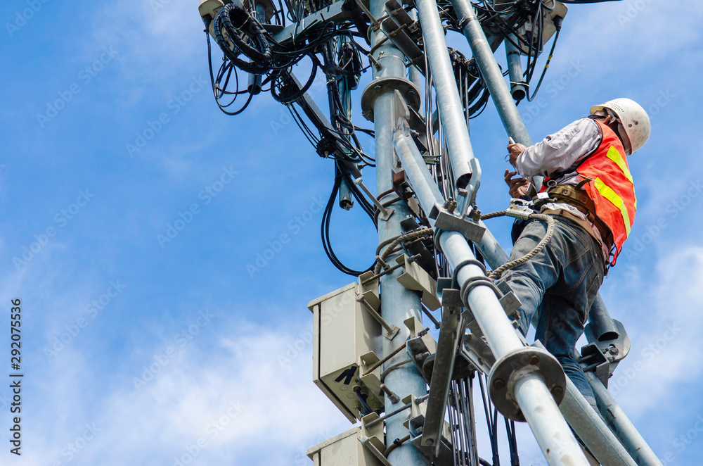 technician working on high telecommunication tower,worker wear Personal Protection Equipment for working high risk work,inspect and maintenance equipment on high tower. - obrazy, fototapety, plakaty 