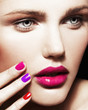 Close-up beauty portrait of young pretty model with bright make-up and manicure. 