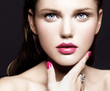 close-up portrait of attractive young model with bright make-up and manicure