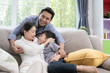 © FrameAngel - Asian family father, mother and son smiling together in living room, happy family concept