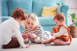 © Olesia Bilkei - cute kids, siblings playing together on the floor at home