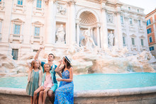 Travel Family Trowing Coin At Trevi Fountain, Rome, Italy For Good Luck.