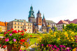 Summer view of Wawel Royal Castle complex in Krakow, Poland. It is the most historically and culturally important site in Poland. Flowers on a foreground