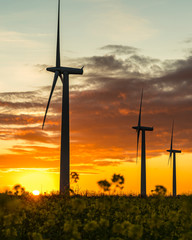 wind turbines at sunrise in the english countryside with a dramatic sky