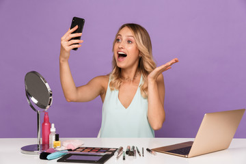 Sticker - Shocked young woman talking by mobile phone.