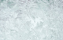 Beautiful Festive Frosty Pattern With White Snowflakes On A Blue Background On Glass