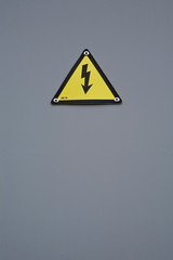 Signal of danger of electrocution from high voltage isolated in grey