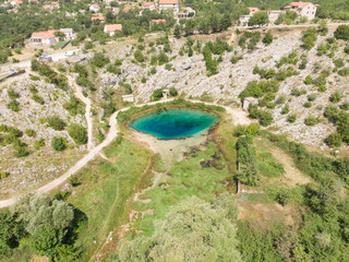 Canvas Print - The cave spring of the Cetina River (izvor Cetine) in the foothills of the Dinara Mountain is named Blue Eye (Modro oko). Cristal clear waters emerge on the surface from a more than 100 m deep cave