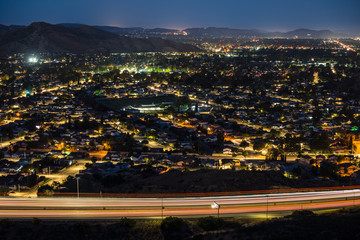 Predawn night view of Simi Valley commuter freeway traffic and suburban homes near Los Angeles in Ventura County, California.