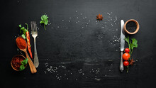 The Background Of Cooking. On A Black Wooden Background. Top View. Free Space For Your Text.