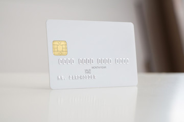 Wall Mural - White blank bank card on soft blurred background