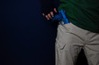 © syahrir - asian man holds a gun. Gun in his pants isolated on black background.