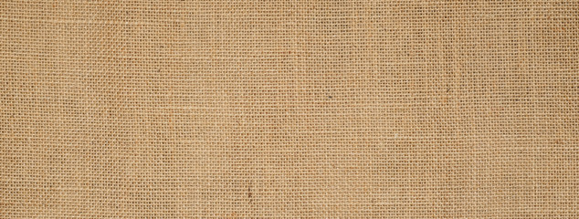 Wall Mural - Cotton woven fabric background with flecks of varying colors of beige and brown. with copy space. office desk concept / Hessian sackcloth burlap woven texture background