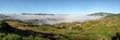 High resolution panorama - typical Madagascar landscape at Alakamisy Ambohimaha region fog rolls over green valley with terraced rice field, clay houses on small hills, higher mountains in background
