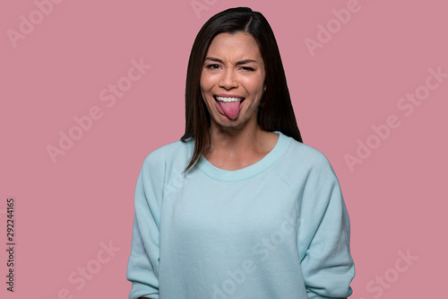 Fotografía Woman making funny goofy face with tongue out, expressive comedic asian american