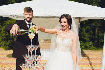 Wall Mural - groom and bride with a bouquet, posing in their wedding day. Enjoy a moment of happiness and love.