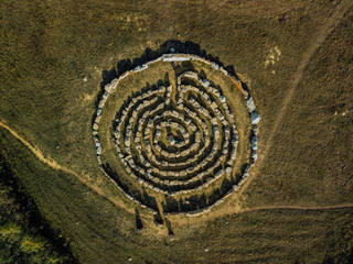 Spiral labyrinth made of stones, top view from drone