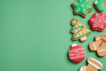 Wall Mural - Flat lay composition with tasty homemade Christmas cookies on green background, space for text