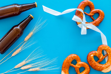 Wall Mural - Beer festival Octoberfest. Pretzels and beer on blue background top view space for text frame