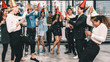© Mongkolchon - group of diversity business people having fun together in corporate new year and Christmas party with music and dancing at workplace