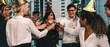 © Mongkolchon - group of diversity business people having fun and having wine glass toasting together in corporate new year and Christmas party with music and dancing at workplace