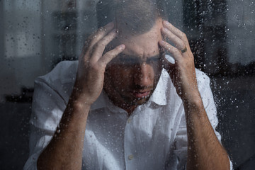 selective focus of pensive upset man at home