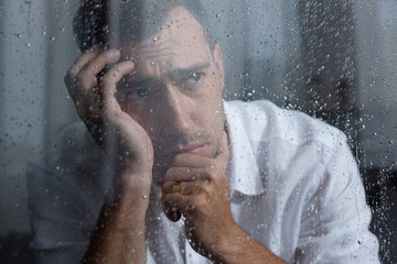 Wall Mural - selective focus of upset man looking away at home