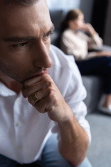 Wall Mural - pensive sad man propping face with hand at home