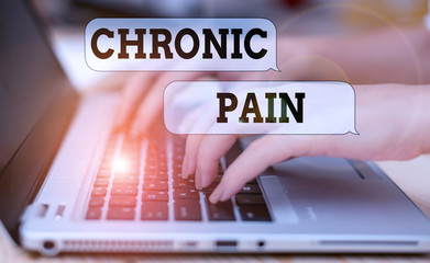 Wall Mural - Writing note showing Chronic Pain. Business concept for pain that is ongoing and usually lasts longer than six months woman with laptop smartphone and office supplies technology