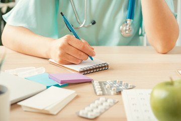 Canvas Print - Female medicine doctor filling patient medical form or prescription