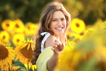 Beautiful Young Woman In Sunflower Field On Summer Day