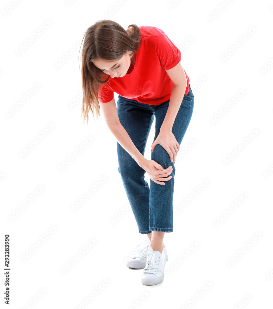 Young woman suffering from pain in knee on white background