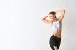 Beautiful sporty woman on light background. Weight loss concept