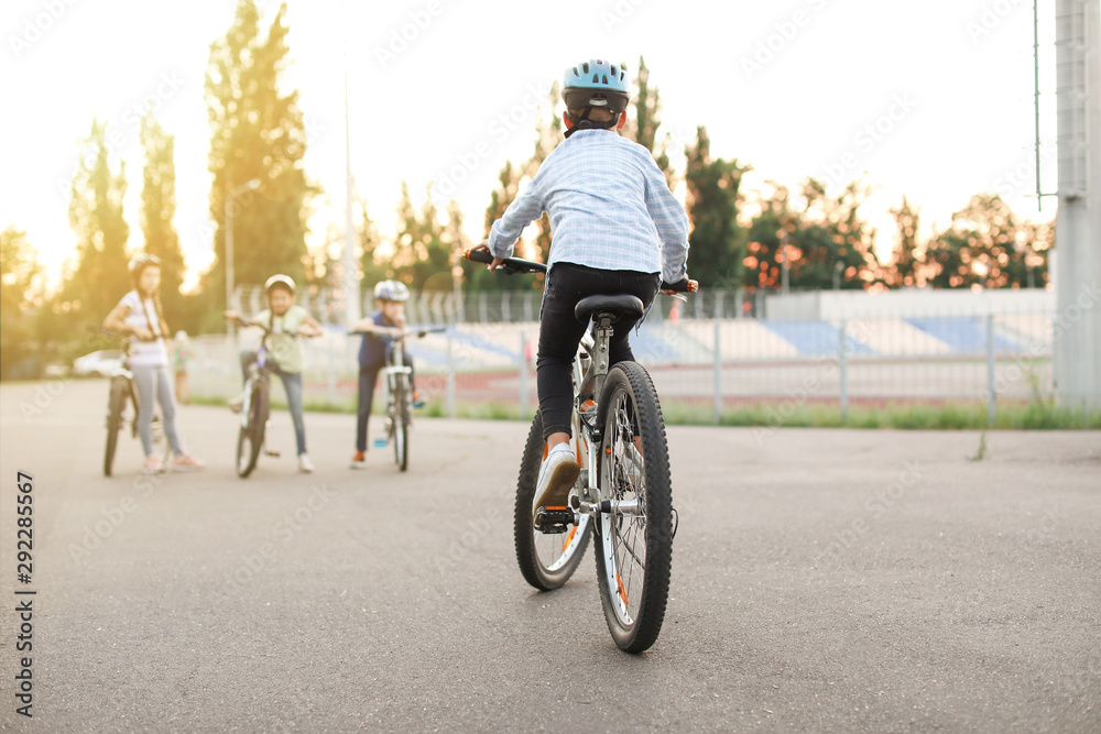 Cute children riding bicycles outdoors